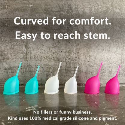 Curved for comfort. Easy to Reach Stem. No fillers or funny business.
Kind uses 100% medical grade silicone and pigment. Kind Cup menstrual cups pictured in profile showing patented ergonomic shape and long removal stem. Cups shown in aqua, clear, and violet in both size regular and small. Patented, ergonomic menstrual cups - period care designed just for you.